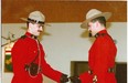 Lee Johnston (right) presents his twin brother Leo Johnston with his RCMP badge, when Leo became a Mountie.