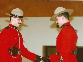 Lee Johnston (right) presents his twin brother Leo Johnston with his RCMP badge, when Leo became a Mountie.
