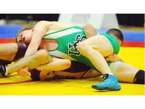 Josh Bodnarchuck (in green) beat Trevor Banks at the CIS wrestling championships medal matches at the University of Alberta main gym on Saturday, Feb. 28, 2015.