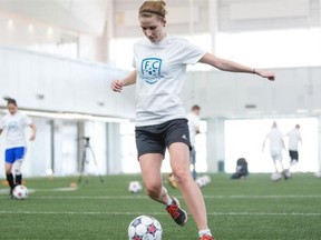Journal reporter Alicja Siekierska boots a ball during a soccer training session for reporters with FC Edmonton head coach Colin Miller on Wednesday at the Commonwealth Community Recreation Centre.
