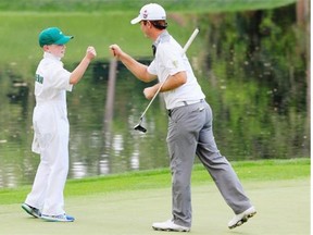 Kevin Streelman of the United States bumps fists with his caddy, Ethan Couch of Spruce Grove, Alta., during the Par 3 Contest prior to the start of the 2015 Masters Tournament at Augusta National Golf Club on April 8, 2015 in Augusta, Georgia.