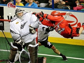 Lacrosse Leap, an image of Calgary Roughnecks forward Curtis Dickson scoring on Edmonton Rush goalie Aaron Bold during the National Lacrosse League West Division Final game action in Edmonton last May.