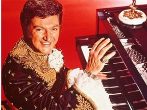 Liberace at the piano.