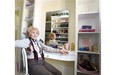 Lila Lofts, 95, in her walk-in closet where her purses, shoes and clothing are all organized by colour