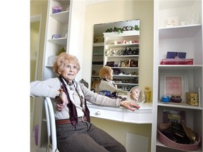 Lila Lofts, 95, in her walk-in closet where her purses, shoes and clothing are all organized by colour