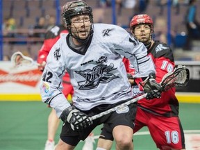 Mark Matthews of the National Lacrosse League Edmonton Rush runs towards a loose ball with Mike Carnegie of the Calgary Roughnecks in pursuit March 8, 2015, at Rexall Place in Edmonton.