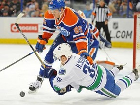 Martin Marincin (85) of the Edmonton Oilers, takes down Henrik Sedin of the Vancouver Canucks at Rexall Place in Edmonton.