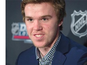 Connor McDavid can barely hide his abject disappointment after learning his future likely lies in Edmonton. So why is he smiling?