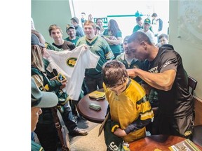 Meet-and-greet autograph session with slotback Adarius Bowman, signing jerseys at the Eskimos Team Store at Commonwealth Stadium. Many fans brought their kids to sign them up for the Eskimos Kids Club.