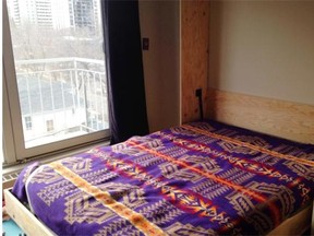 The Murphy bed in Justin Wheler’s condo looks normal when it’s down, concealing the desk underneath.