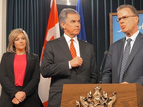 Alberta Education Minister Gordon Dirks, right, explains why the PC government reversed course and passed a bill granting students in any school the right to form a gay-straight alliance support group as with Premier Jim Prentice and PC backbencher Sandra Jansen look on in Edmonton on Tuesday March 10. 2015.