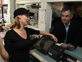 Alberta Premier Jim Prentice talks to owner Mandy Kenworthy during a campaign stop at Jack's Drive In in Spruce Grove on Tuesday Apr. 7, 2015.