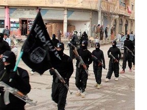 This undated file image posted on a militant website on Tuesday, Jan. 14, 2014 shows fighters from the Islamic State of Iraq and the Levant (ISIL) marching in Raqqa, Syria.