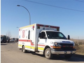 An ambulance arrives Tuesday afternoon at the Edmonton Waste Management Centre after a worker was trapped under a pile of recycling.