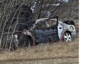 RCMP on the scene where a body was found inside a burned vehicle on a service road just north of Highway 16 and Range Road 15, west of Stony Plain, April 3, 2015.