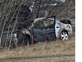 RCMP on the scene were a body was found inside a burned vehicle on a service road just north of Highway 16 and Range Road 15, west of Stony Plain, April 3, 2015.