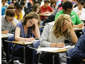 Students write final exams at Harry Ainlay High School in June 2010. The exams will now account for 30 per cent of a student’s final mark, down from 50 per cent.