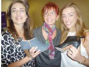Sisters Jus­tine (left) and Ken­dall Bar­ber (right) spoke about the risks they took to start their high­ly suc­cess­ful Poppy Bar­ley shoe busi­ness when in­vit­ed by NorQuest President Jodi Ab­bott (cen­tre) to ad­dress her col­lege’s In­ter­na­tion­al Woman’s Day cele­bra­tions. The sis­ters slipped off their boots to show sam­ples of foot­wear that have sold on­line to thou­sands of women across Can­ada.