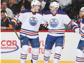 Oscar Klefbom #84, Justin Schultz #19, and Derek Roy #8 of the Edmonton Oilers celebrate a second period goal against the Colorado Avalanche at the Pepsi Center on March 30, 2015 in Denver.