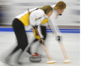 A pair of sweepers from Kim Link’s Manitoba team zip down the ice during the Canadian senior women’s curling championship at the Thistle Curling Club on March 22, 2015.