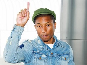 Pharrell Williams appears at the Empire State Building in New York on Friday, March 20, 2015 to mark the United Nations’ International Day of Happiness. Williams’ song Happy is one of the top-selling singles of all time.