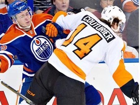 Philadelphia Flyers forward Sean Couturier checks Edmonton Oilers defenceman Martin Marincin (85) during NHL action in Edmonton on Dec. 28, 2013.