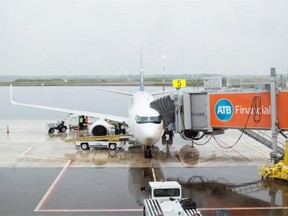 A plane arrives at the new Fort McMurray International Airport on Monday, June 9, 2014. The Fort McMurray Airport Authority is contracting out all custodial services, putting 24 people out of work.