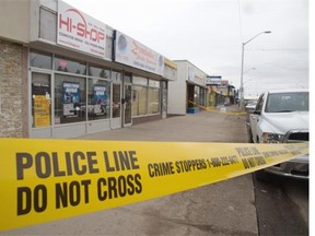 Police investigate the scene where a man’s body was discovered lying near 118th Avenue and 125th Street.