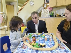 Premier Jim Prentice chats with five-year-old Jayden Whiskeyjack and childcare worker Kandra Wandyka at the Norwood Child and Family Resource Centre before making an announcement about supports for working families in Edmonton on Friday March 27, 2015.