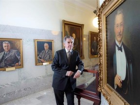 Premier Jim Prentice takes a moment in the Legislature Library to consider his predecessors in the Hall of Premiers.