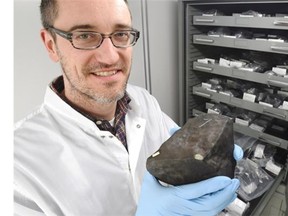 Professor Chris Herd, University of Alberta Department of Earth and Atmospheric Sciences, holds the first rock found from many pieces of the Bruderheim meteorite crash 55 years ago this week.