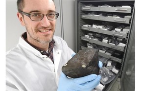 Professor Chris Herd, University of Alberta Department of Earth and Atmospheric Sciences, holds the first rock found from many pieces of the Bruderheim meteorite crash 55 years ago this week.