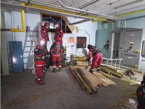 Rescue workers prepare to extract injured people, played by Thorhild High School drama students, during a mock disaster training exercise at the old school (condemned and soon to be demolished) in Thorhild on Thursday Feb. 26, 2015.