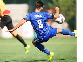 Ritchie Jones of FC Edmonton leaves his feet to kick the ball towards the Fort Lauderdale Strikers net during a North American Soccer Legue game at Clarke Field on Aug. 24, 2014.