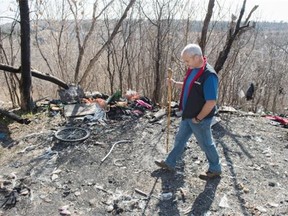 Riverdale resident Ray Vallee stands among the stunning amount of trash left behind by homeless people living in the river valley just below Jasper Avenue and about 92 Street.