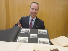 Robert Desmarais, head of Bruce Peel Special Collections Library, holds a photo album which is part of the memorabilia purchased as part of the Prairie Roots Endowment Fund.