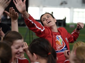 EDMONTON, ALBERTA, APRIL 28, 2015: Team Canada's Christine Sinclair high fives with players from the U12 Red Deer Renegades while taking part in the unveiling of a Canada Post Team Canada Soccer stamp at Commonwealth Stadium in Edmonton on Tuesday Apr. 28, 2015. ( Photo by John Lucas/Edmonton Journal) (for a story by John MacKinnon)