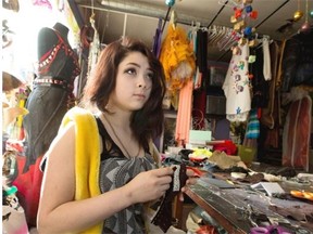Saidee Gosselin talks about the importance of bus passes for youths as she works on a leather cuff at iHuman on March 10, 2015 in Edmonton.