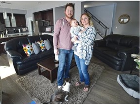 Scott and Shea Hand with their baby Ari, 8 months, in their home in the Ruisseau neighbourhood in Beaumont.