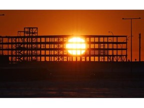 The sun setting through a building under construction just off Anthony Henday Drive in southwest Edmonton on February 21, 2015.