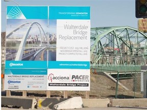 A sign for the Walterdale Bridge Replacement Project stands near the existing Walterdale Bridge in Edmonton on April 8, 2015. The new $155-million bridge has been delayed a full year due to the steel manufacturer not delivering on schedule.