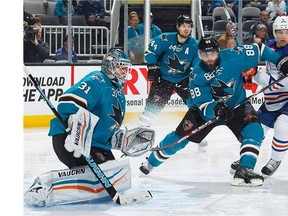 Antti Niemi #31, Brent Burns #88 and Marc-Edouard Vlasic #44 of the San Jose Sharks defend the shot on net against Taylor Hall #4 of the Edmonton Oilers during an NHL game on February 2, 2015 at SAP Center in San Jose, California.