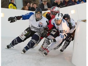 Martin Niefnecker, left, Toni Heikkilae, right, Tyler Roth, back left and Wade Metz fight for position on the last turn during the Crashed Ice elimination round on March 13, 2015 in Edmonton.