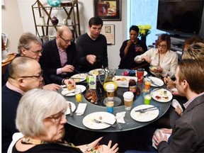 The staff of 10 crowd around a table meant for four, to enjoy their monthly breakfast prepared by Mayor Don Iveson’s executive assistant, Marilyn Hooper.