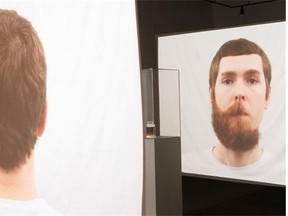 Stephen G.A. Mueller, seen in a frame of his time-lapse video where, one by one, he plucks the hairs from a full beard down to bear skin. The video and the collected hairs are at Latitude 53 through March 28.