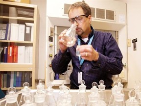 Steve Craik, director of quality assurance, smell tests samples untreated as well as treated water at the Rossdale water treatment plant in April 2013.