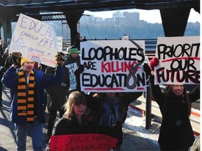 Students from across Alberta march from the University of Alberta to rally on the steps of the legislature Monday.