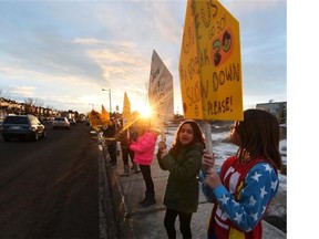 Students from Bessie Nichols and Sister Annata Brockman schools came out with signs urging motorists to slow down in the school zone during a rally in west Edmonton on Monday March 9, 2015.