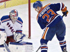 Cam Talbot makes a save on Matt Hendricks on March 30, 2014.