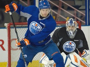 Taylor Hall (4) deflects a puck past goalie  Richard Bachman (32) at the Edmonton Oilers practice at Rexall Place in Edmonton on March 23, 2015.